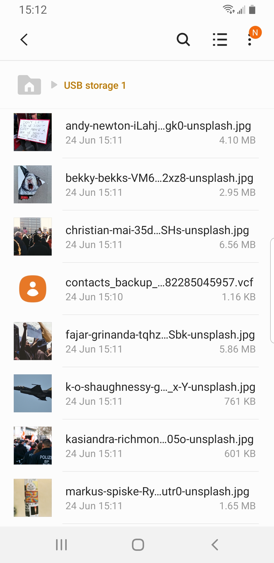 USB storage file list showing backed up photos and contacts